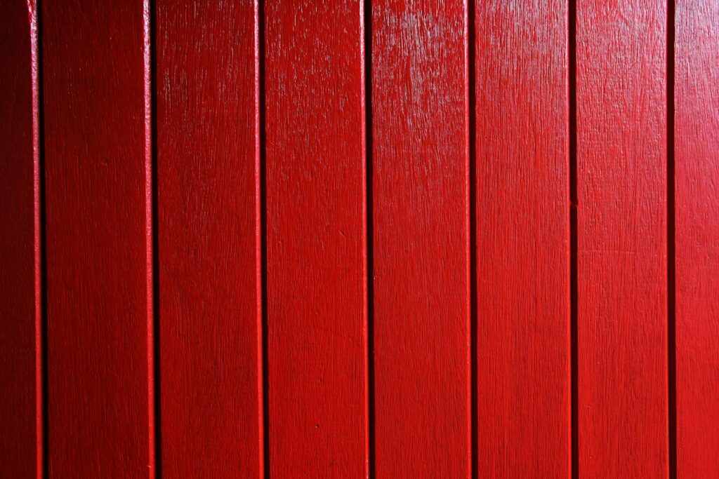 Vivid red wooden planks create a bold and rustic background.