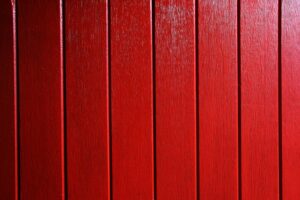 Vivid red wooden planks create a bold and rustic background.